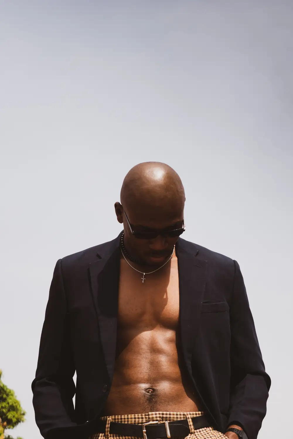 Bare chested black man in cool suit
