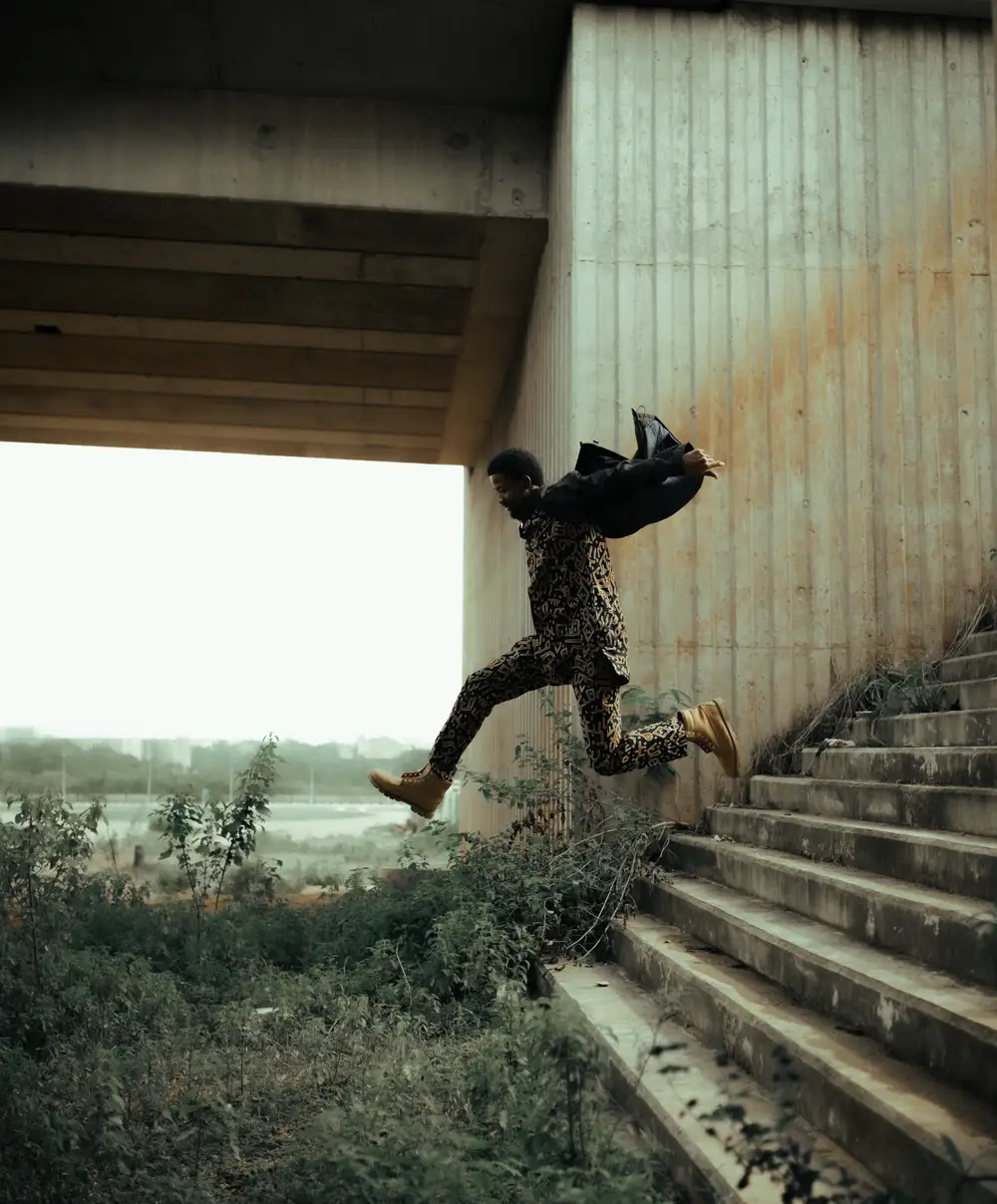 young man jumping over stairs