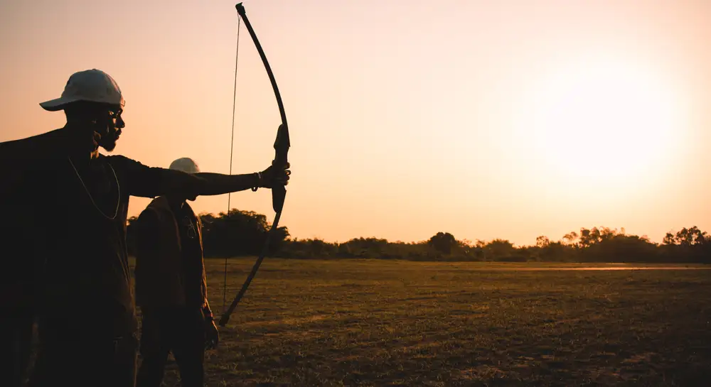 men using bow and arrow