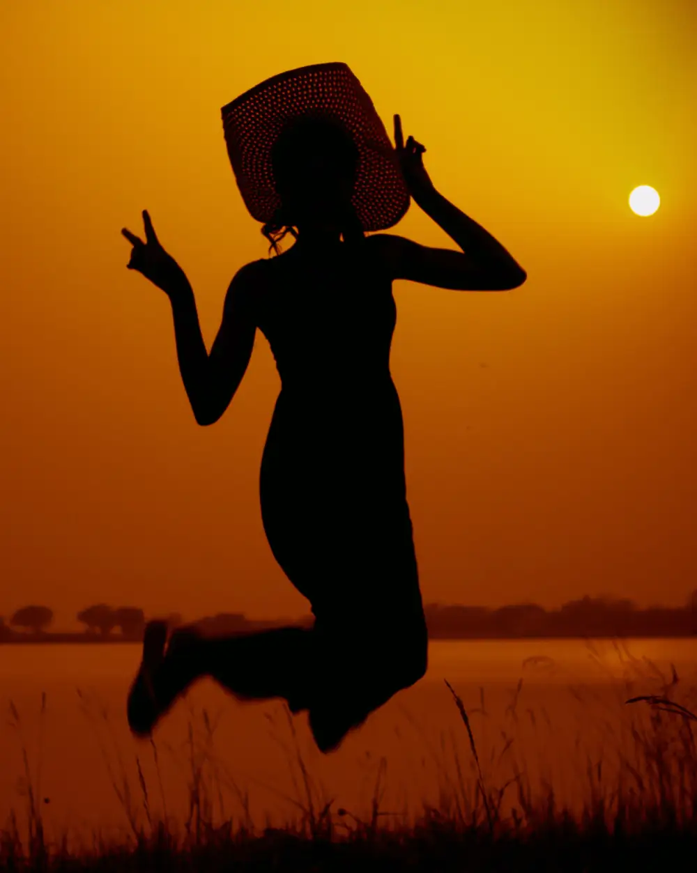 woman jumping in sunset