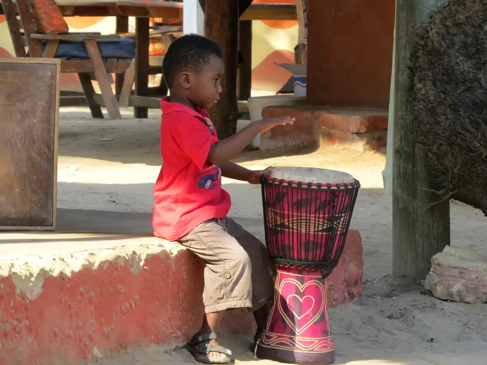 black boy playing a drum