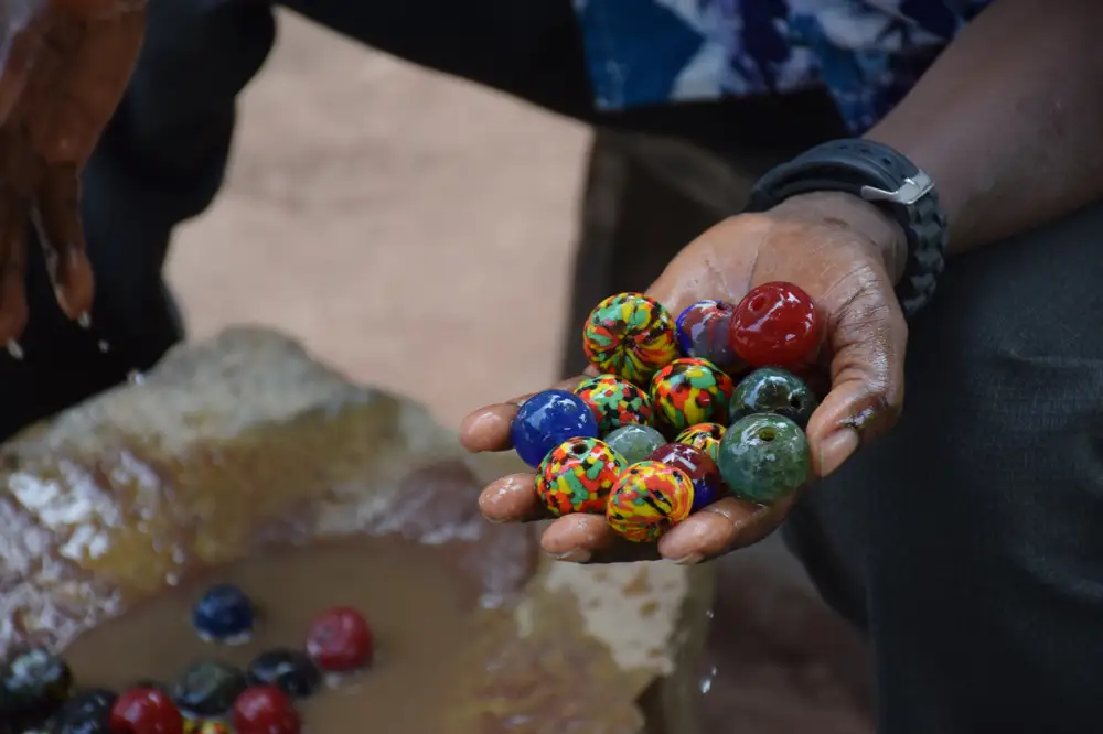 hands holding colorful beads