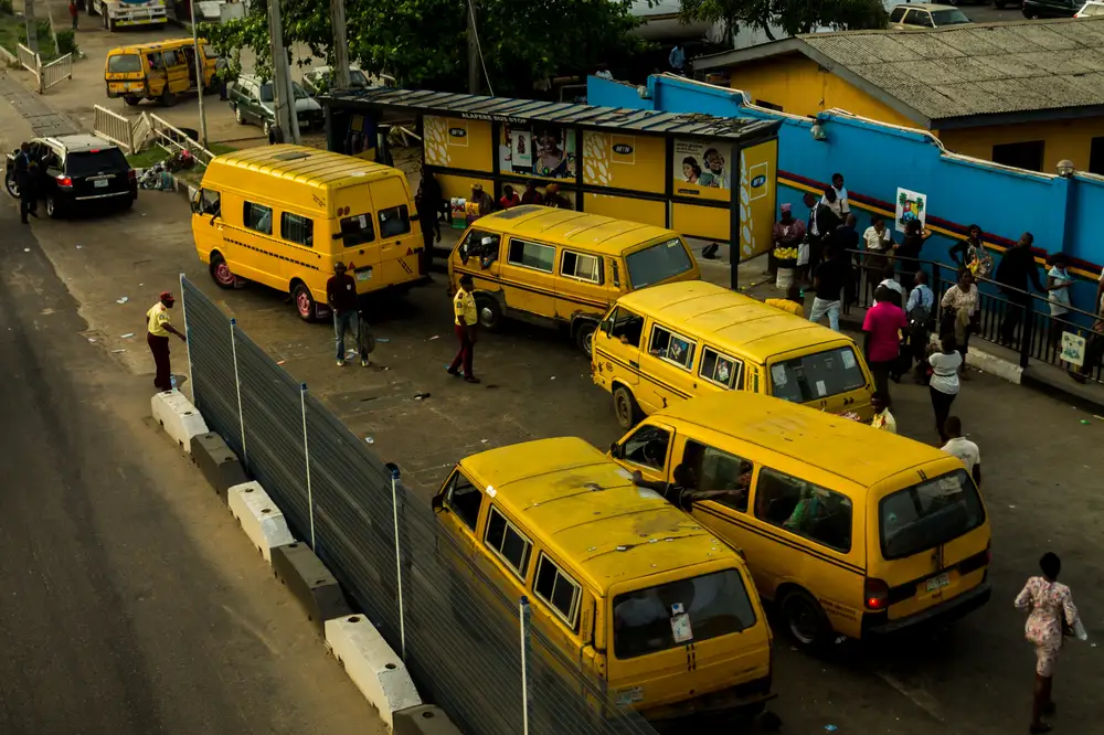 A bus stop in Lagos with the popular yellow buses