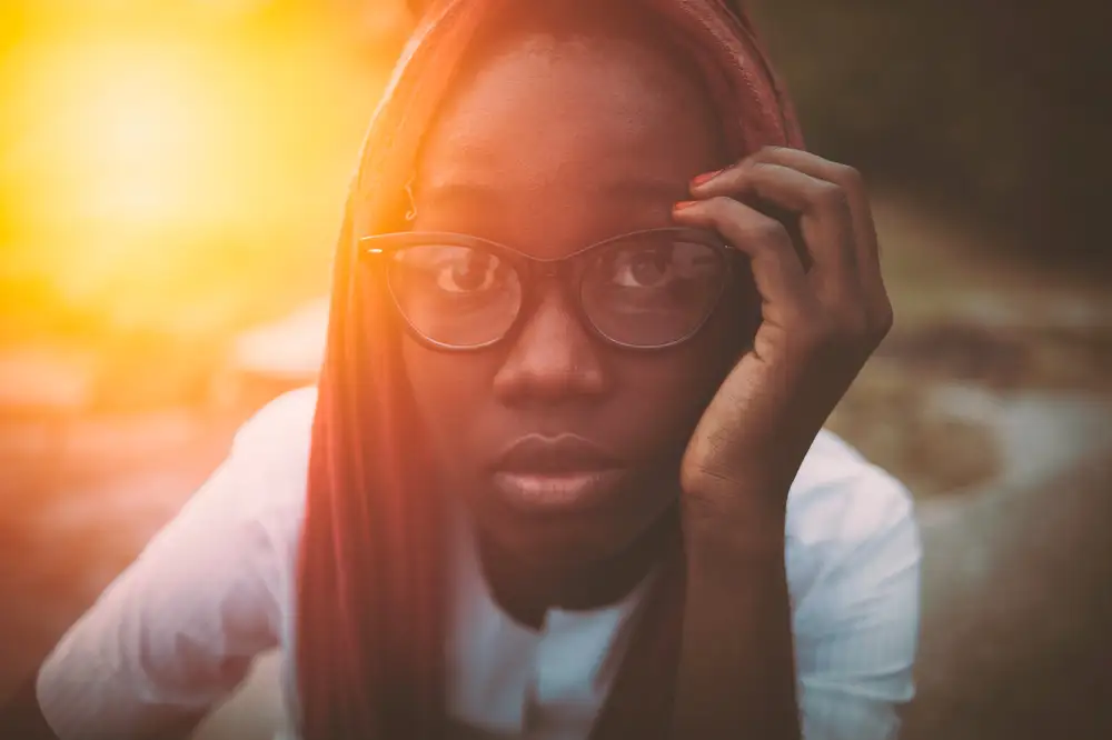 Sun shining on a young girl with glasses