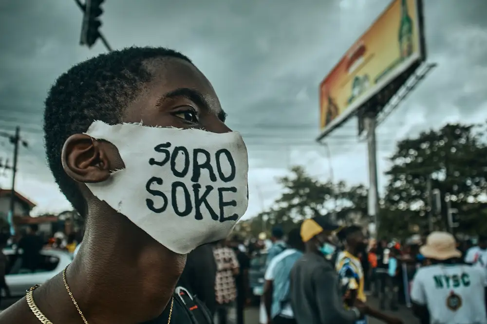 An #endsars End Sars protester's side view showing a word written on the mask he is wearing. Soro Soke is a Yoruba word that means “Speak Up!” It was very popular during the protest.