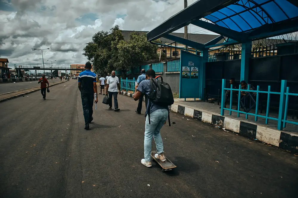 A picture of a young skateboarder skating around in the city of Port Harcourt.