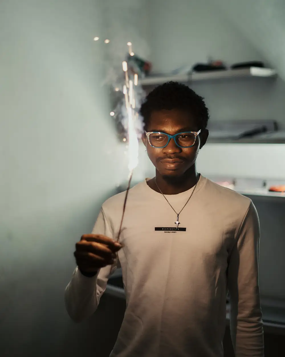 Black African man holding a sparkler to celebrate the new year.