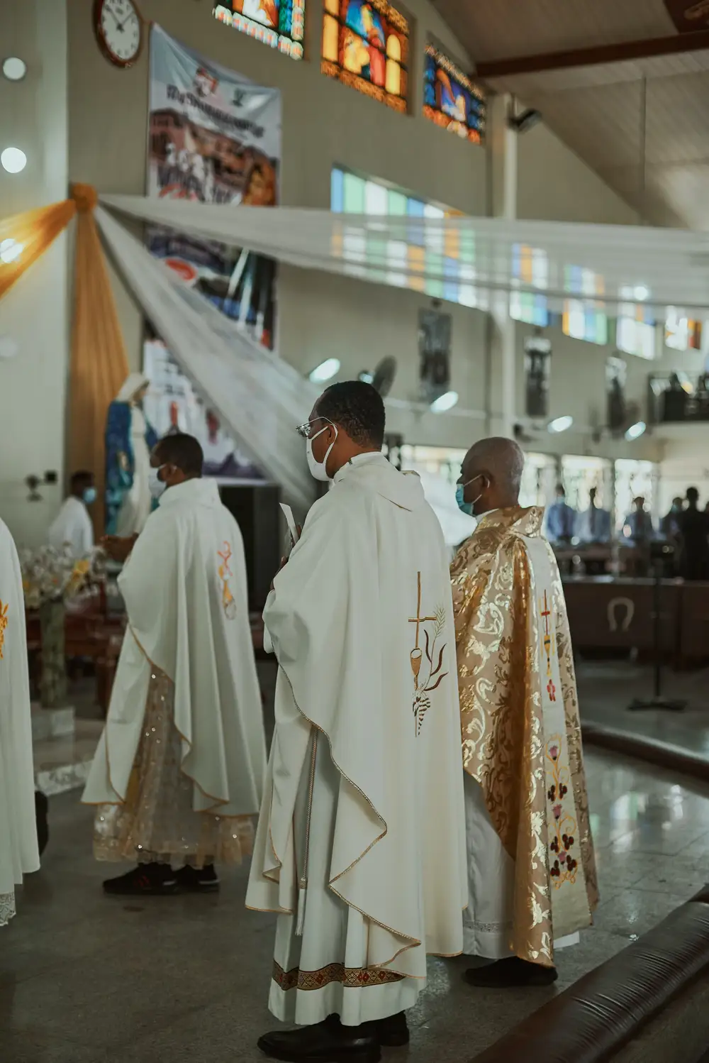 Catholic Priests ministering at the altar.