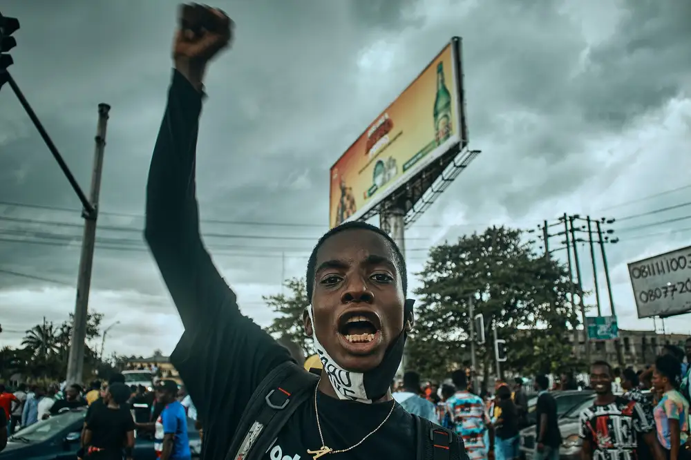 A protester lifting one hand up in the city of Port Harcourt in solidarity and as a sign for the #Endsars protests in Nigeria.