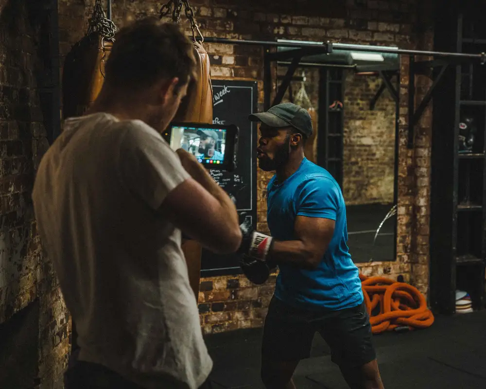 Videographer recording a boxer hitting a silo