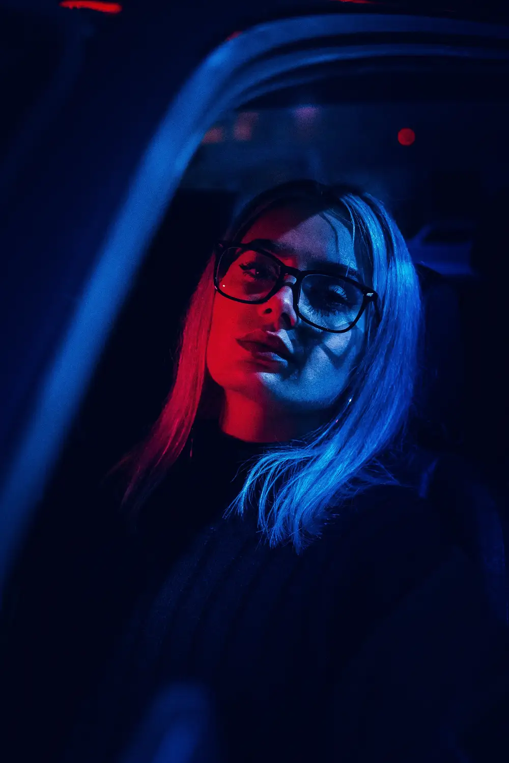 Portrait of a lady in red and blue neon light