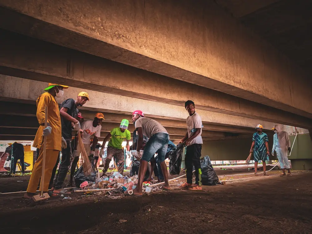 Group of men cleaning under bridges