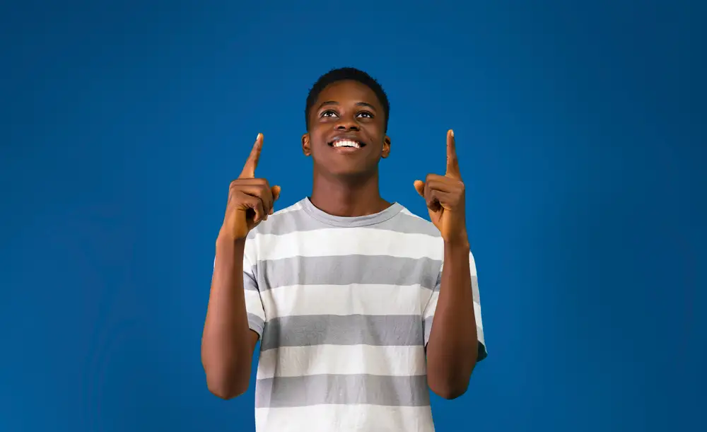 young man pointing upwards
