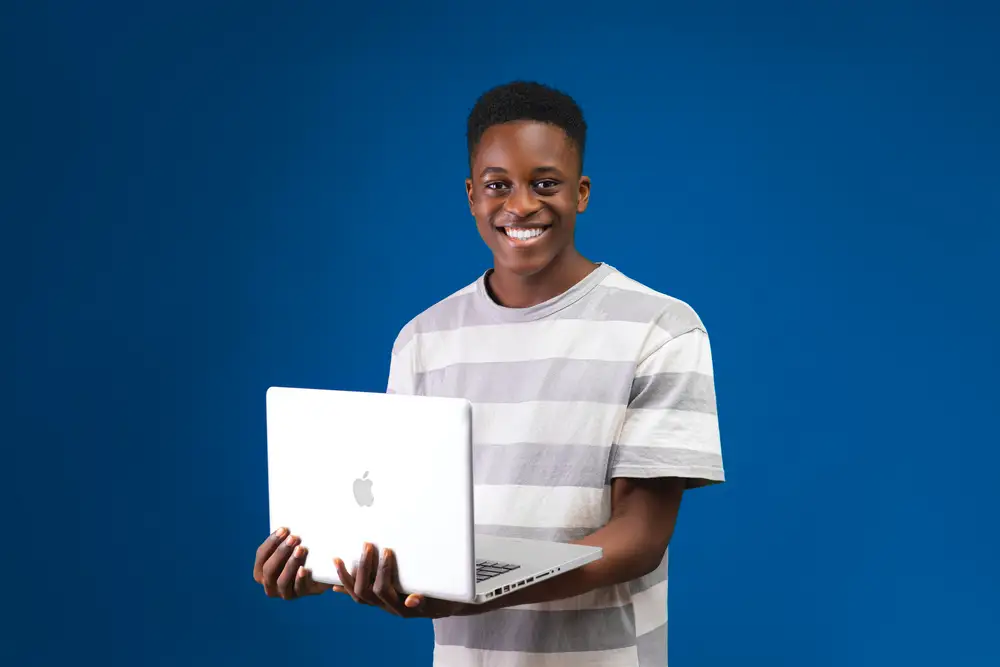 young man holding laptop