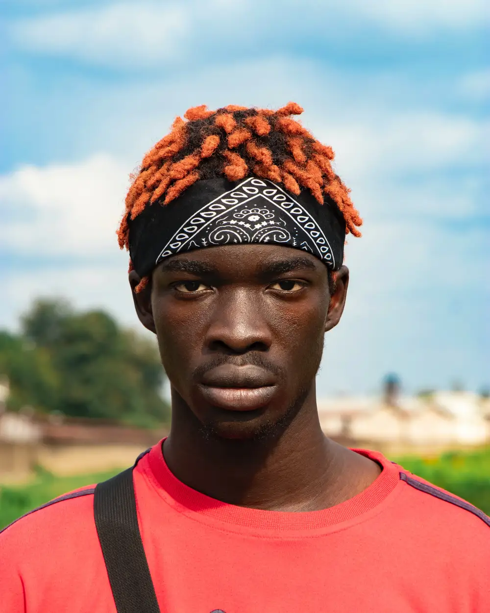 Male model in dyed hair wrapped with bandana