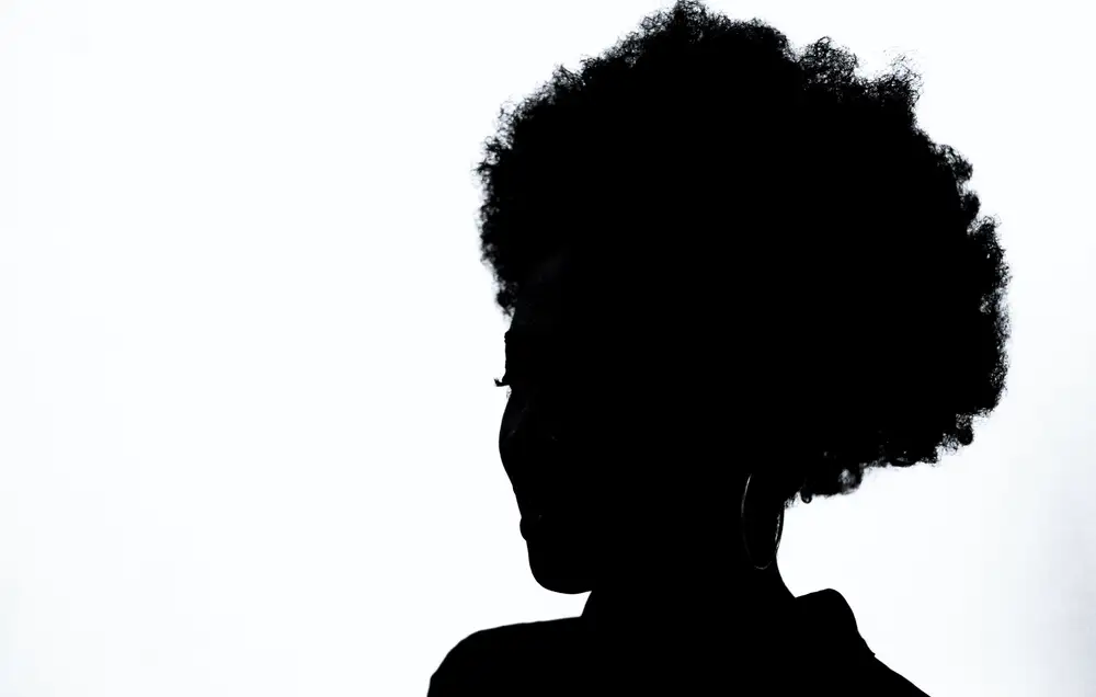 Silhouette of a woman with afro