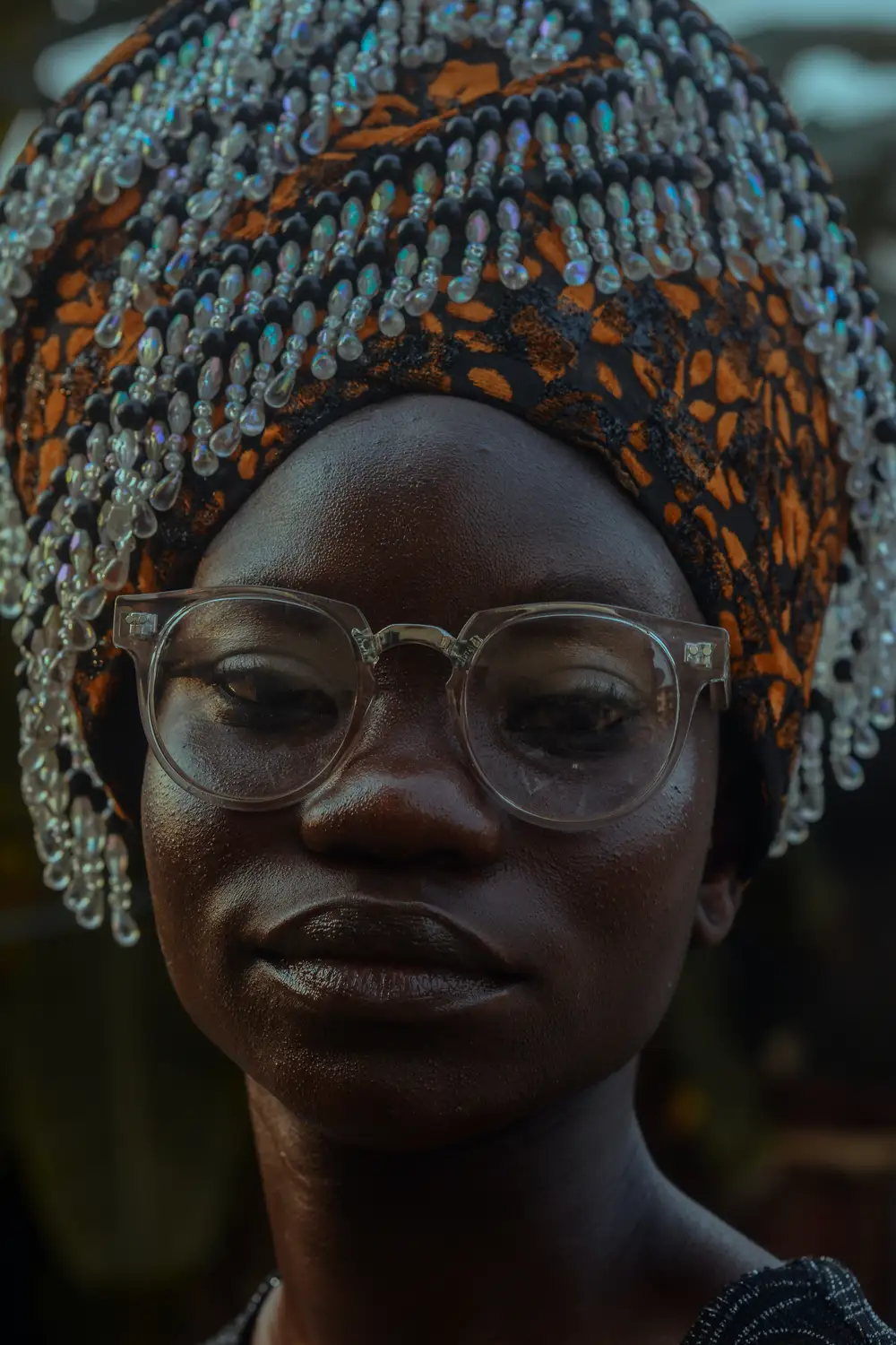 Woman wearing glasses and a beaded headscarf