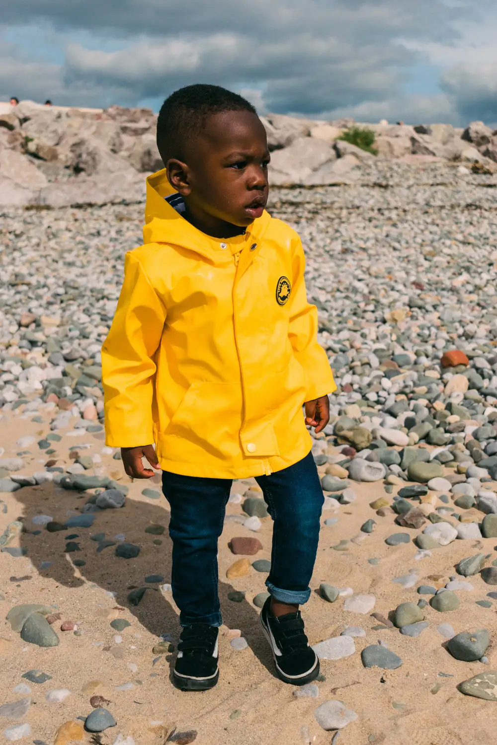 Young boy in a bright yellow coat
