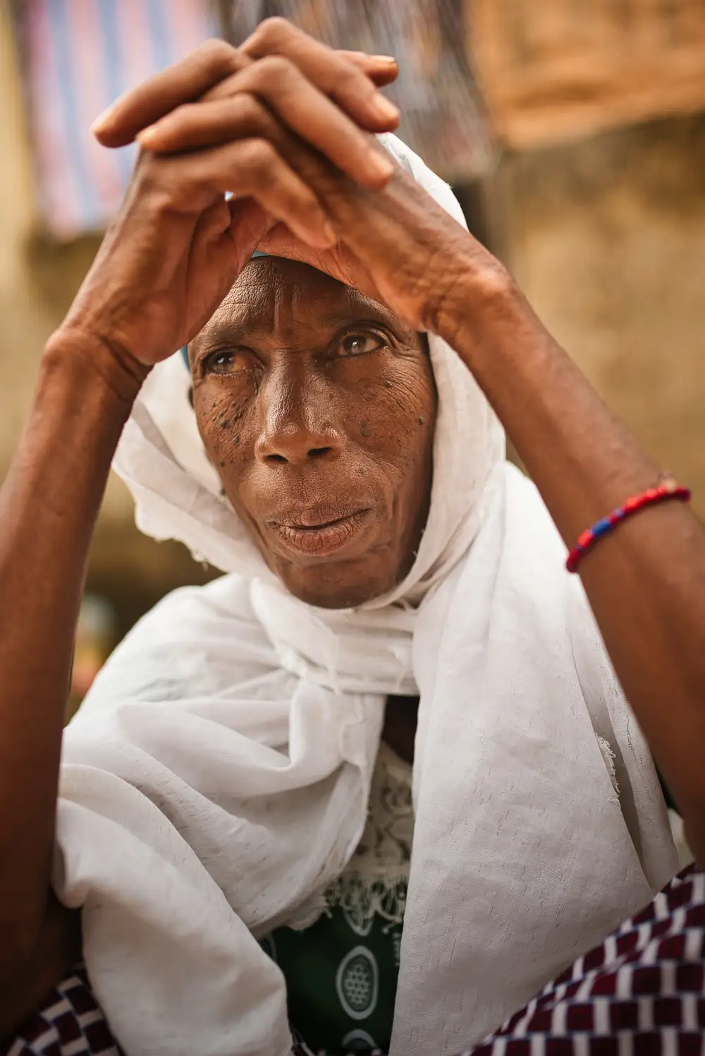 Portraits of a 90-year-old Fulani woman who migrated and now lives in the town of Nmanduono.
