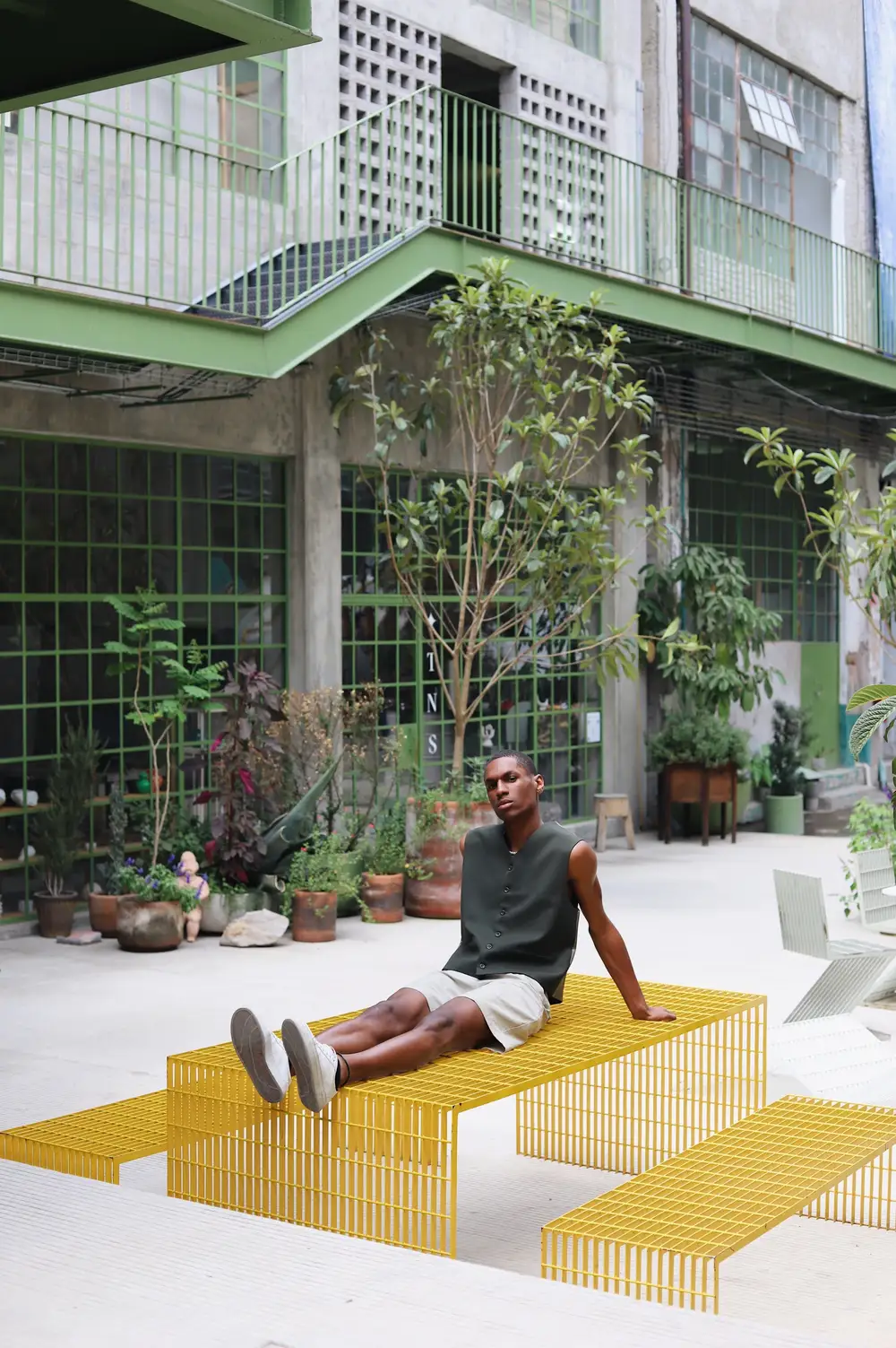 Man resting on yellow grille