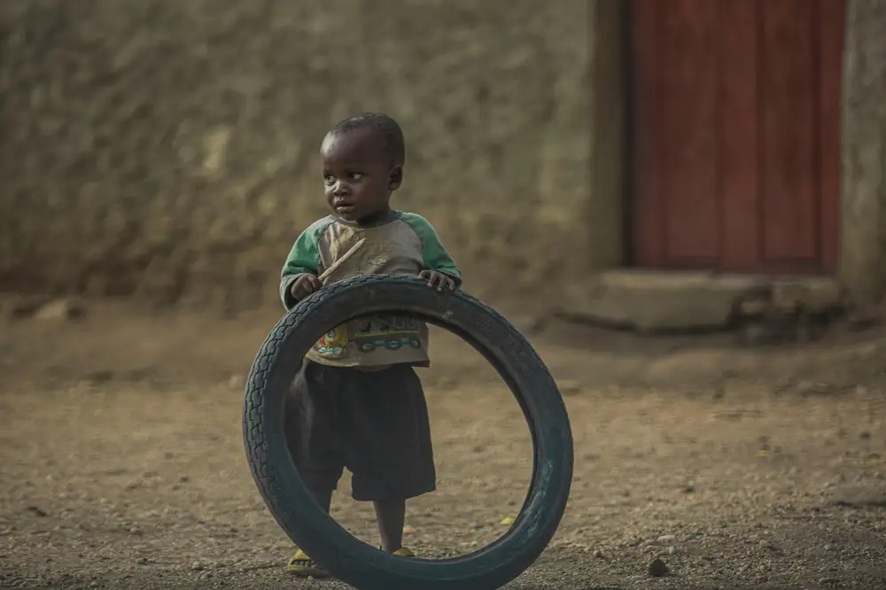 a boy playing with tyre