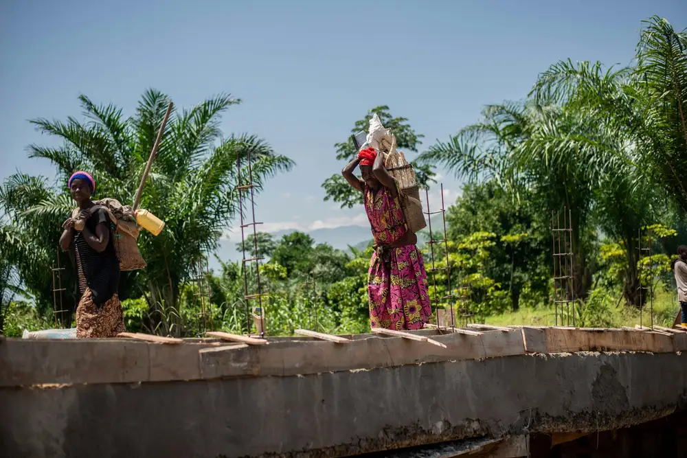 a farmer carrying cassava