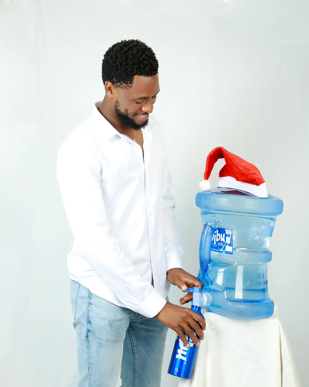 man taking jibu water from a dispenser