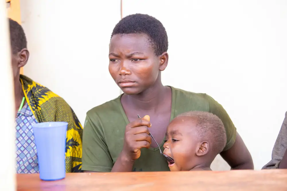 woman feeding a baby