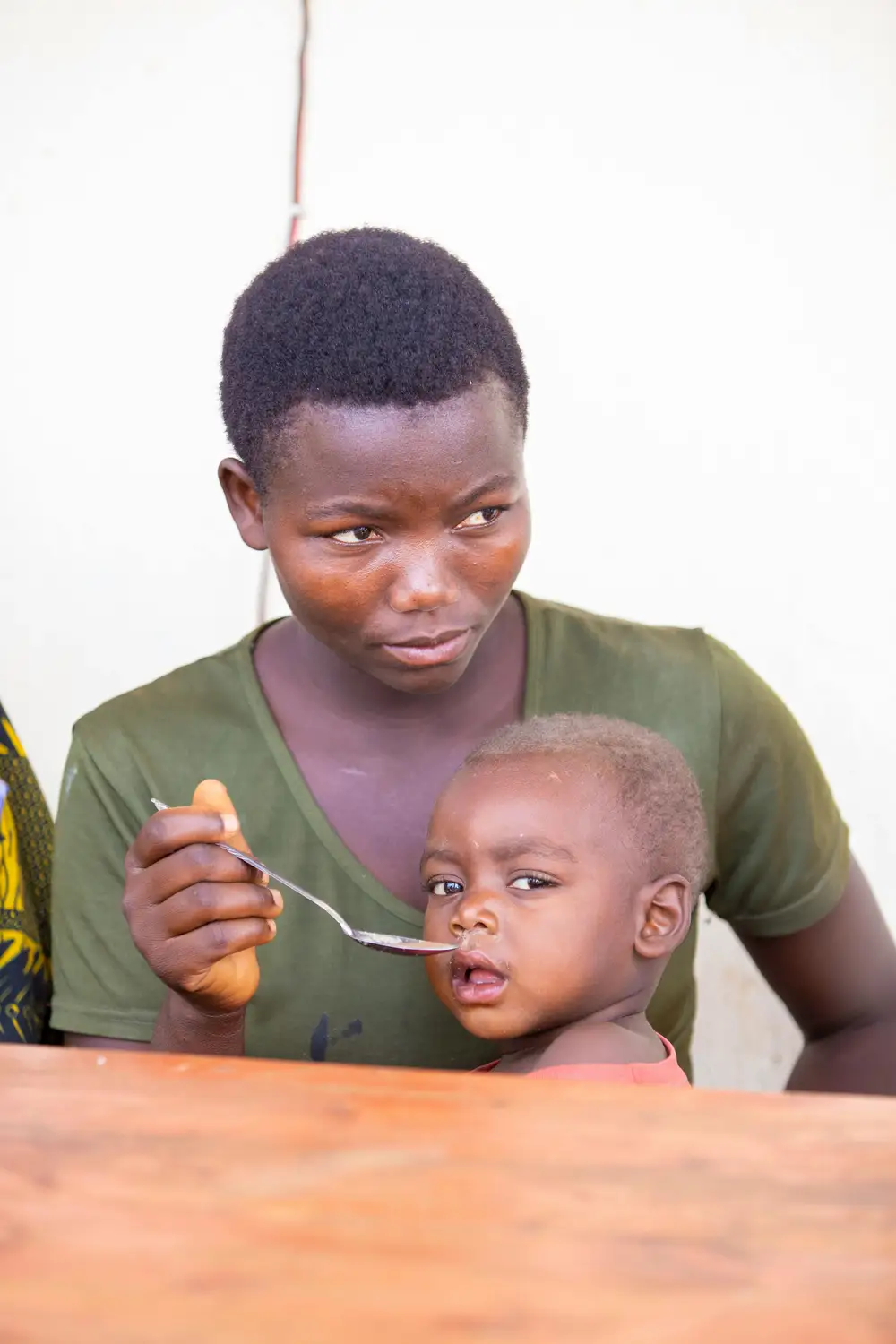 woman feeding a baby