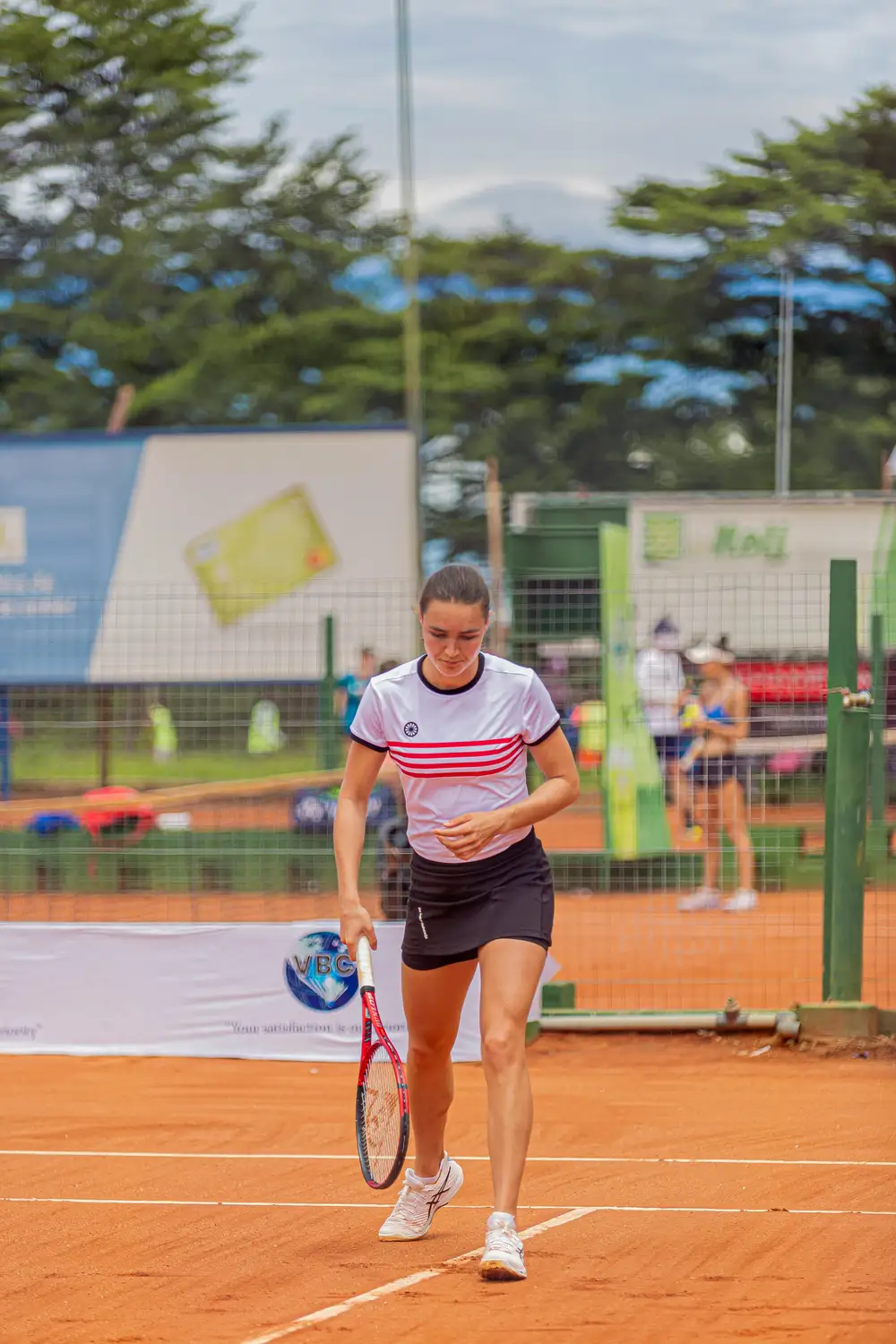 woman playing long tennis