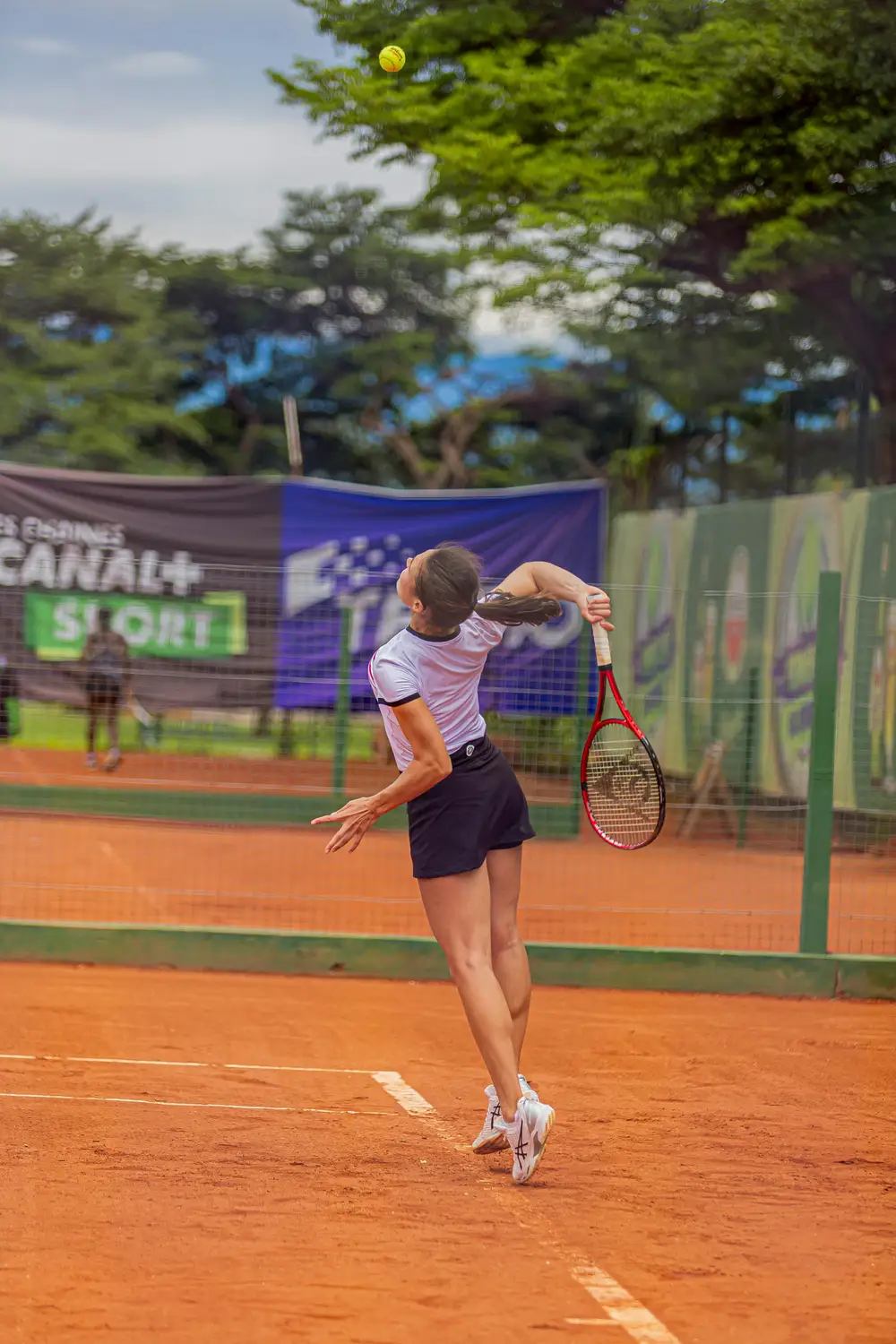 woman playing long tennis