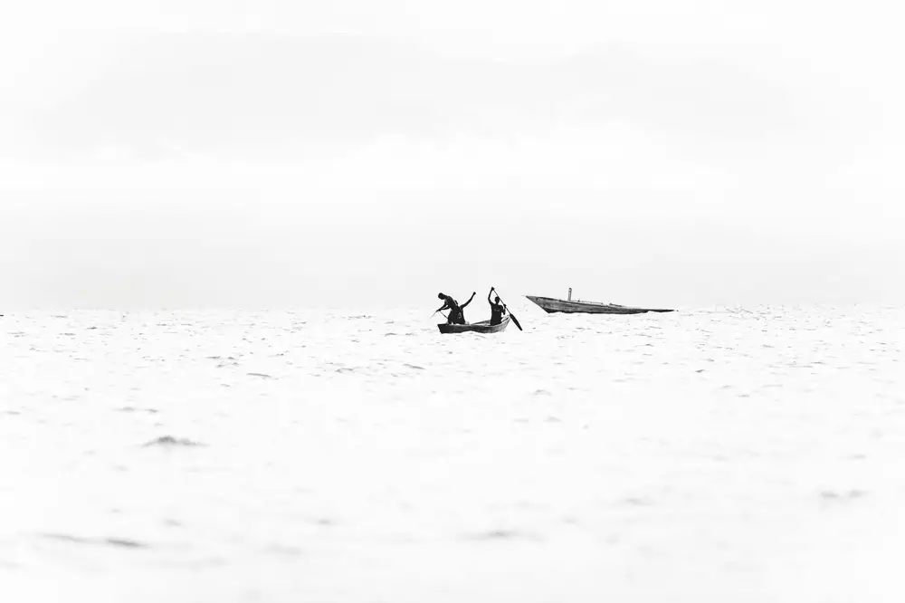 people padding a canoe