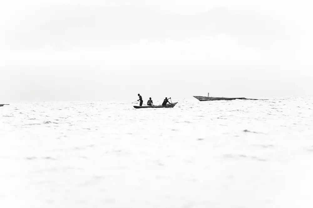 people padding a canoe