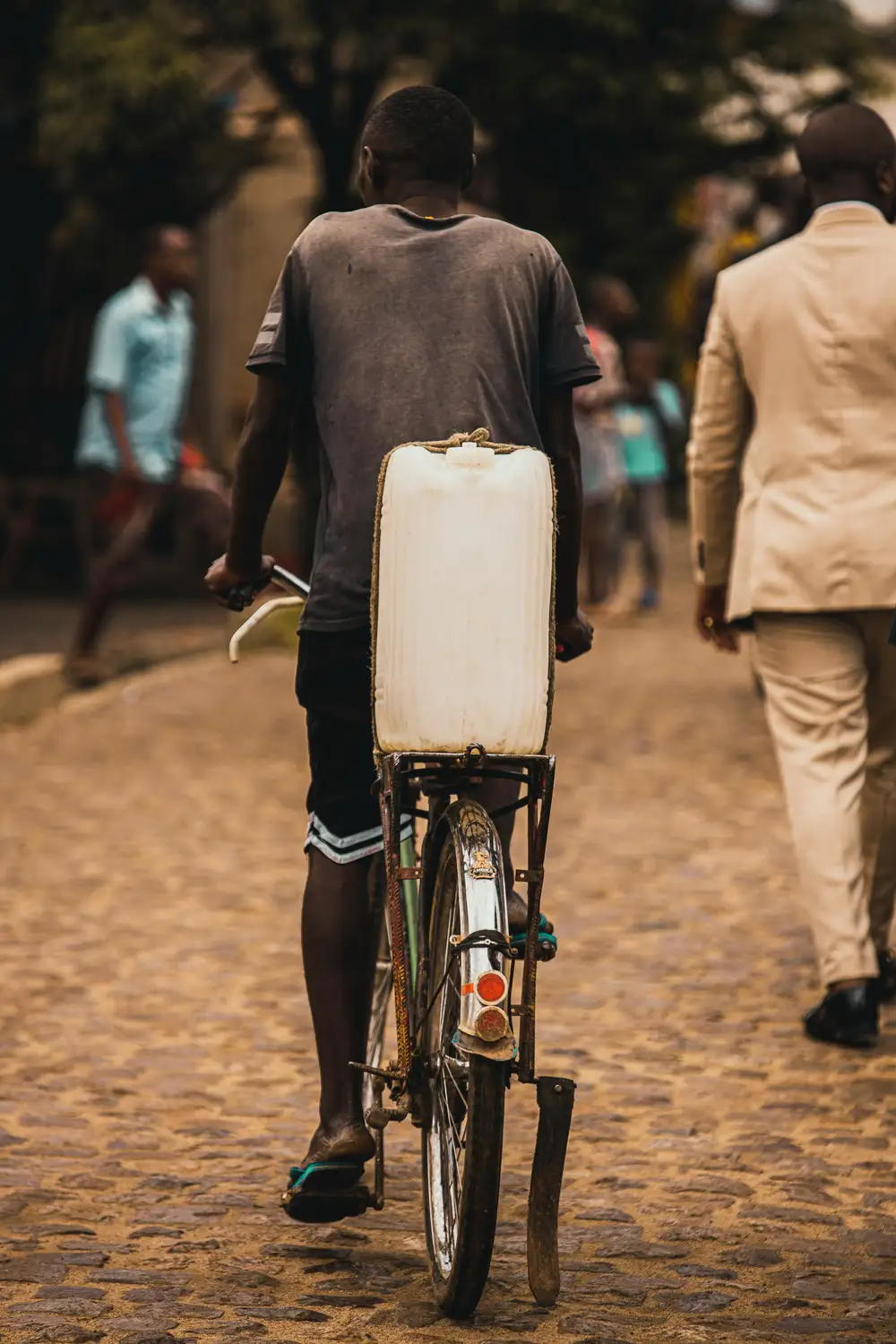 man carrying palmwine on a bicycle