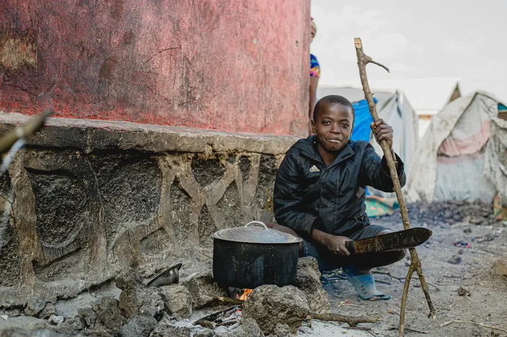 boy making fire for cooking