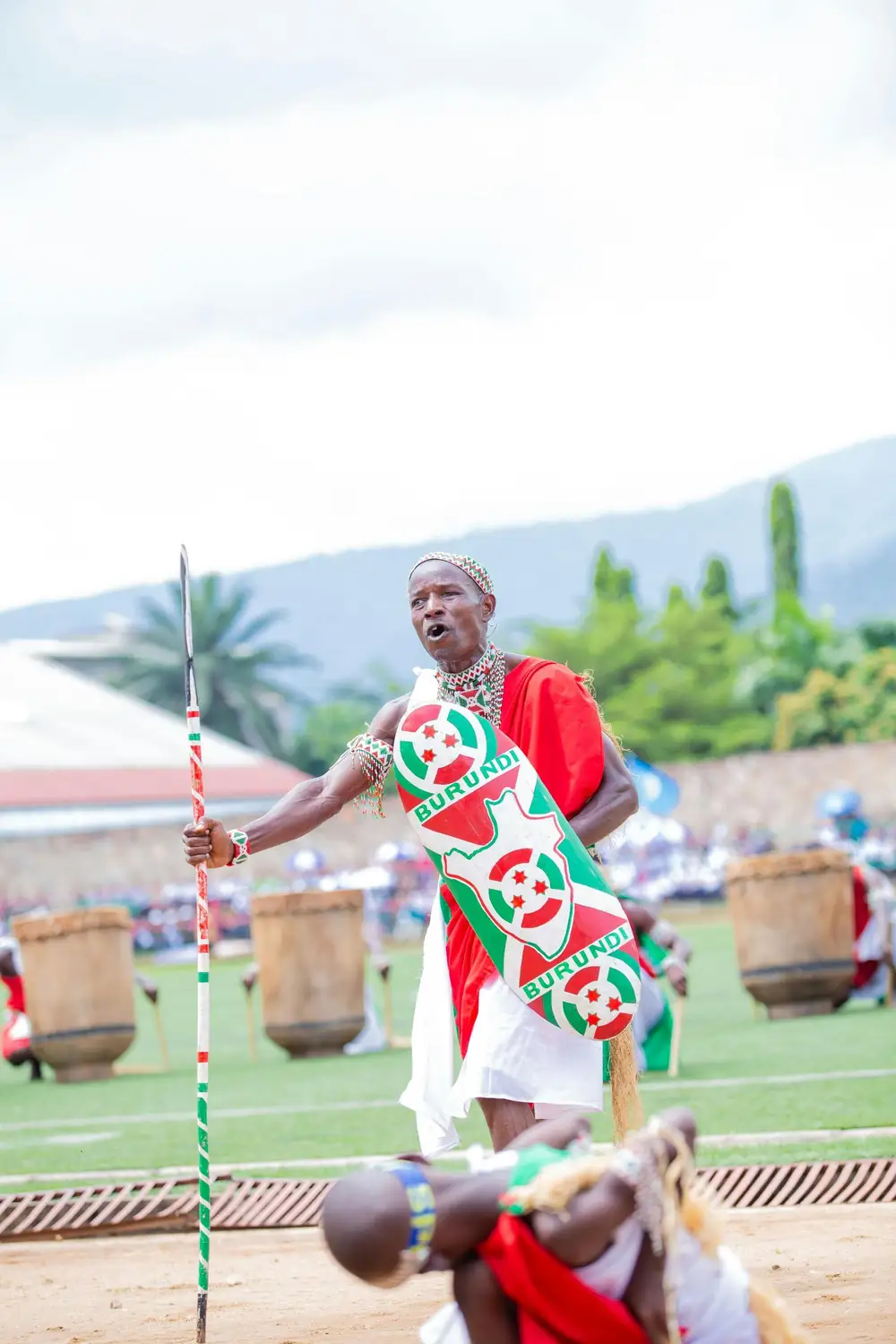 a man holding painted stick