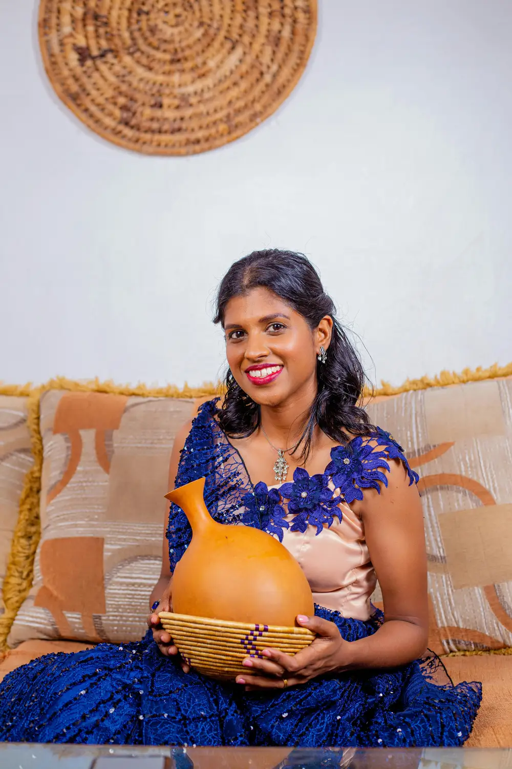 an indian woman holding a calabash