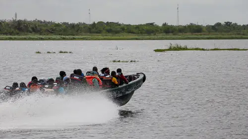 Passengers on a speed boat heading to Seme border