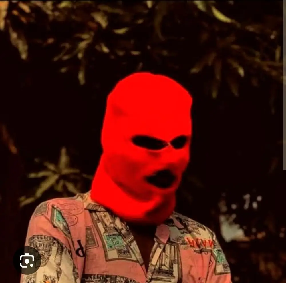 A guy putting on Balaklava